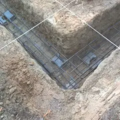 Zbrojenie pod budowę fundamentów, gotowe do zalania betonem. Stopy fundamentowe tworzą solidną podstawę.